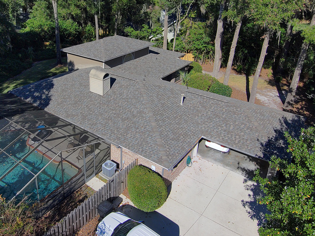 Installation of a new brown asphalt shingle roof on a single-family home by Atlantic Roofing & Exteriors LLC in Gainesville, FL.